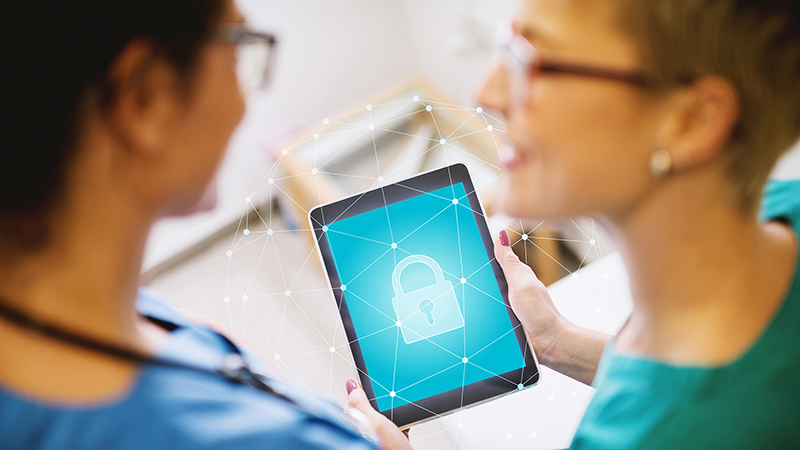 medical professionals looking at tablet device