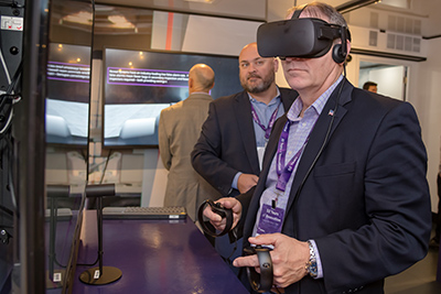 visitor trying a demo inside the Leidos LIVE trailer