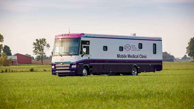 QTC mobile medical clinic parked in a field