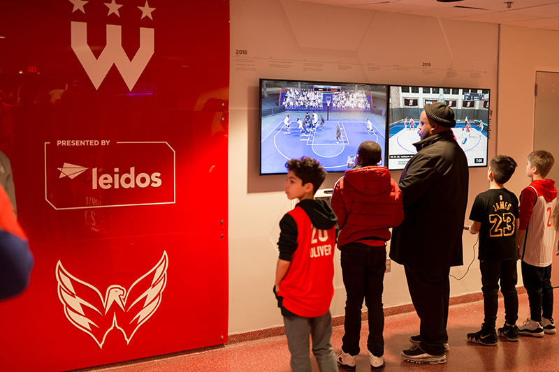 Capital One Arena gaming zone fans playing at the Leidos interactive gaming zone at Capital One Arena