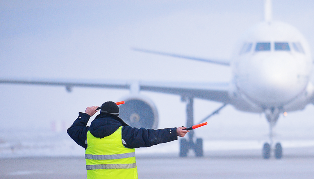 man in front of plane directing