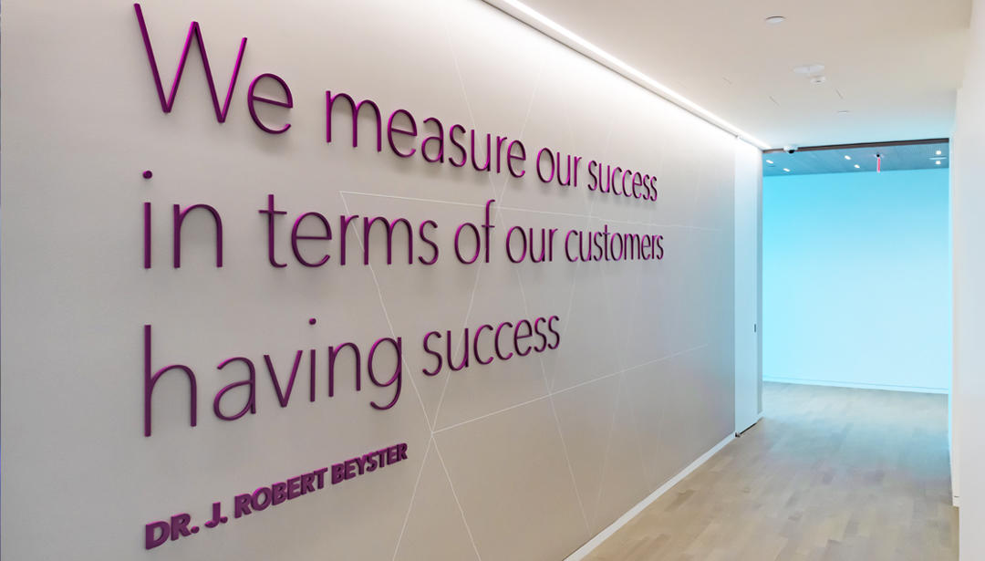 quote on a wall 'we measure our success in terms of our customers having success'