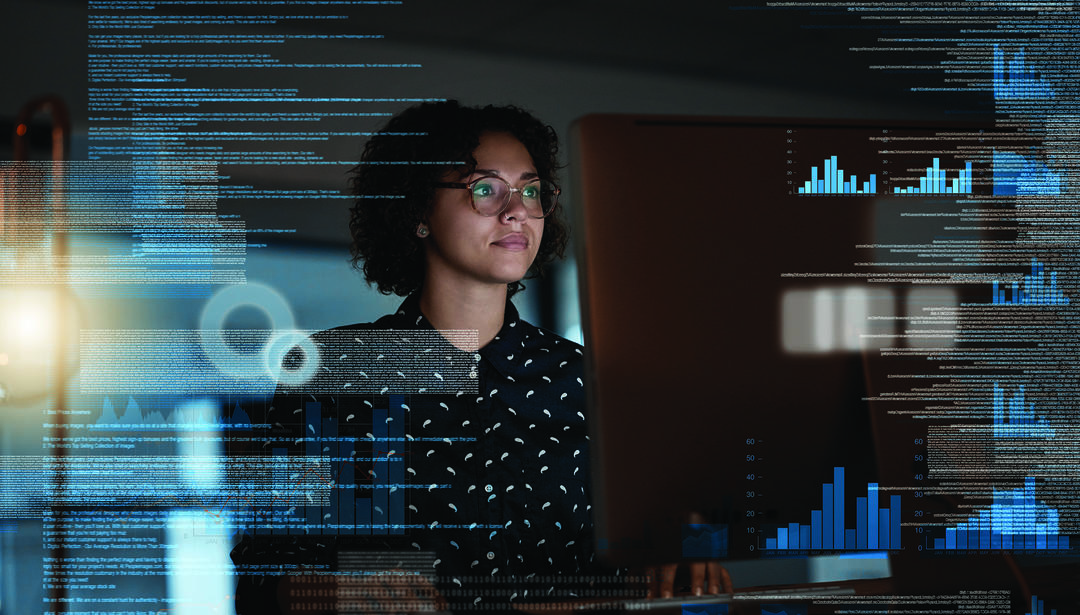Woman at computer with graphical charts