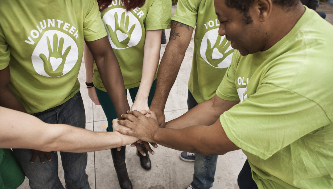 Volunteers holding hands in circle
