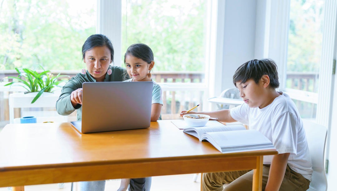 Elementary age boy working on school assignment at home