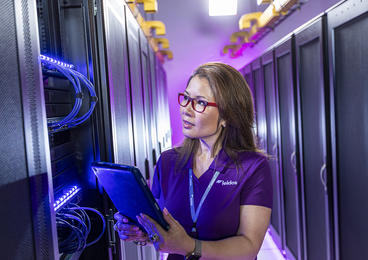 Female Leidos employee holding a tablet