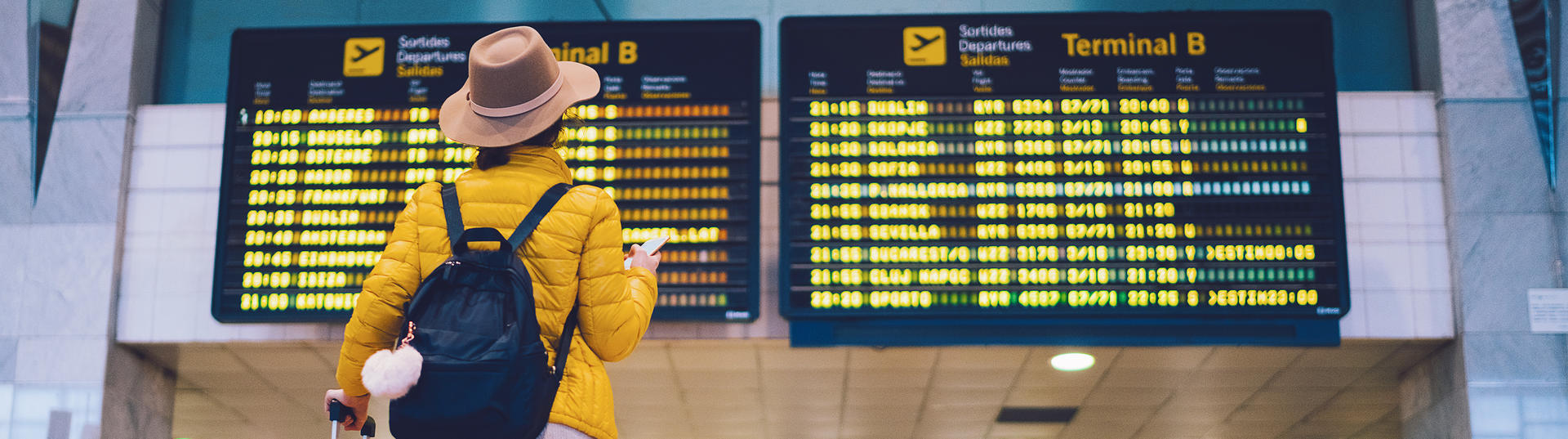 Passenger looking at a departure board