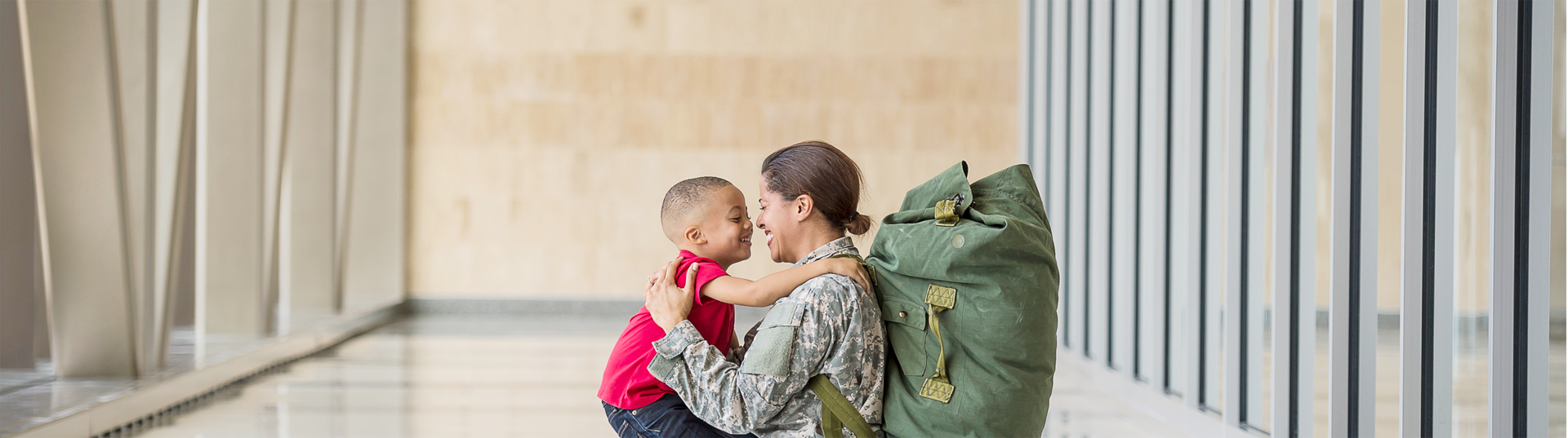 female soldier hugging her son