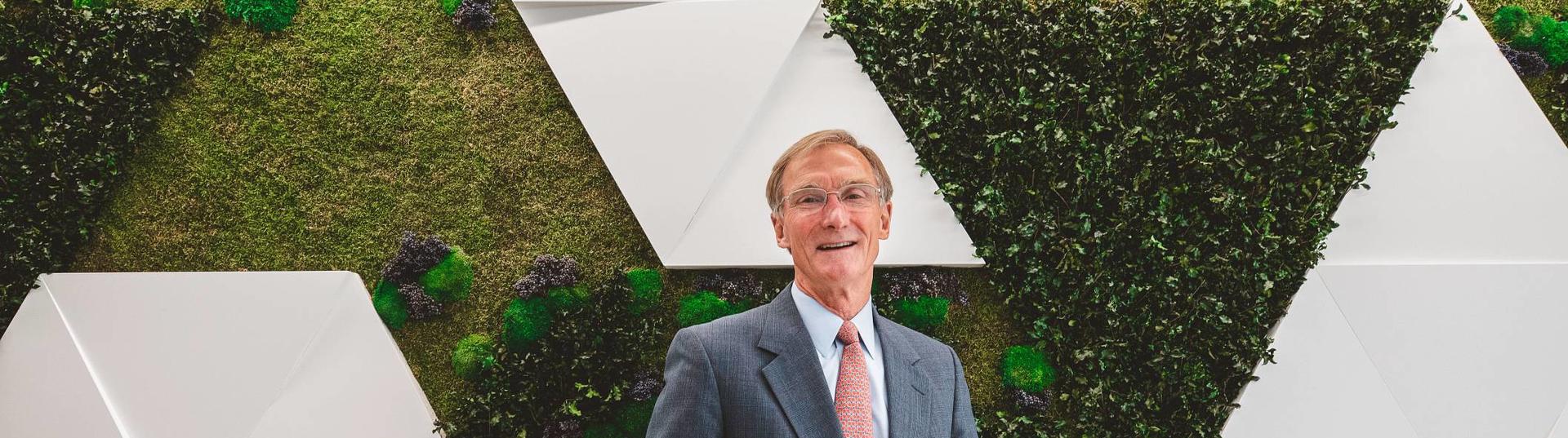 Roger Krone standing in front of a living wall at headquarters