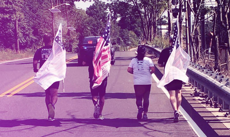 52898119e80ac834b7dbee871a3299bd.jpg Paul and three other runners behind a police escort during the Promise Run