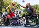 Veterans in wheelchairs playing basketball