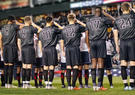 Army Mens Soccer Team lined up on field saluting