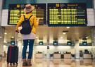 Traveler looking at flight board in airport