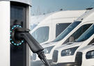A line of trucks being charged by an electric charger