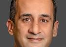 Masood Ahmed pictured in front of a gray background