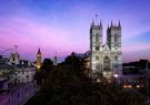 Westminster Abbey in London underneath a blue and purple sky