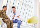A doctor talking to a military man