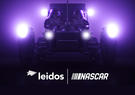 A lunar rover with two astronauts onboard has its headlights as it travels through a purple background. Two logos announce a promotional partnership between Leidos and NASCAR.