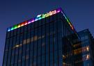 Leidos Global Headquarters at dusk lit up in the colors of the Pride flag