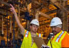 Two workers in an industrial facility