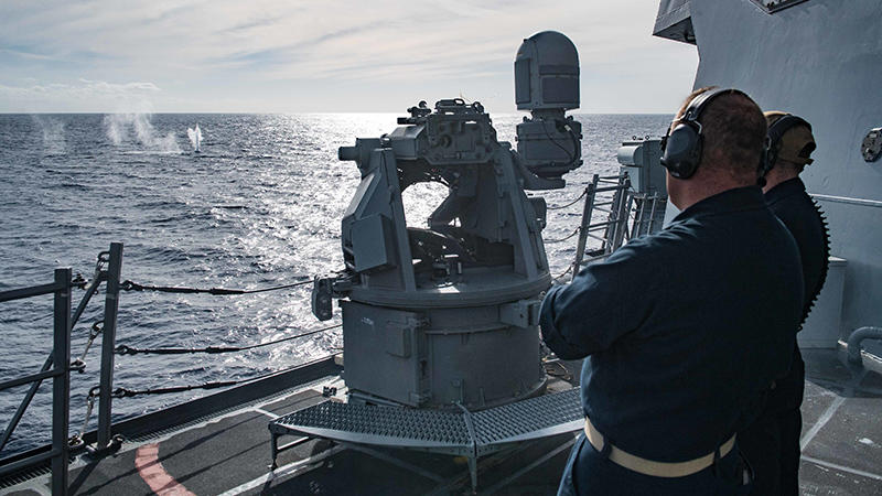Navy crew looking into the ocean