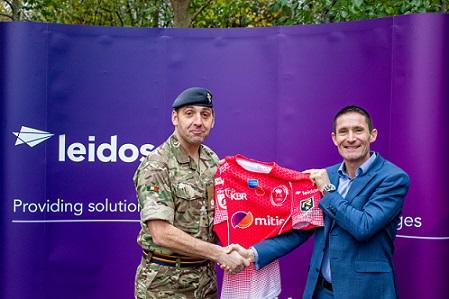 Leidos UK's Damian Alexander holds an Army Rugby Union jersey