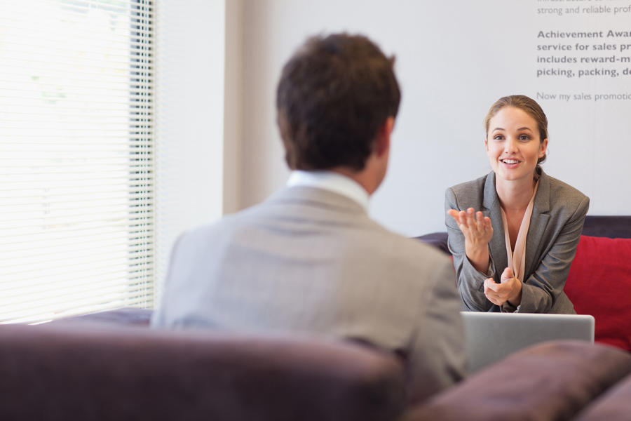 Woman talking to man in interview setting