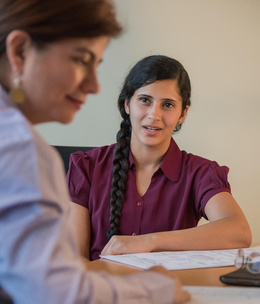 Leidos employees talking during a meeting