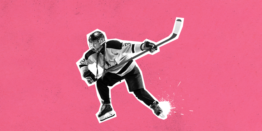 Female hockey player in full gear with stick up in the air