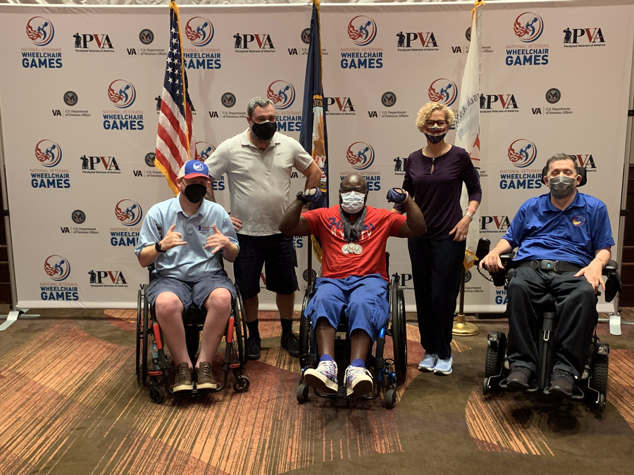 Liz Porter presenting medals to winners at National Veterans Wheelchair Games