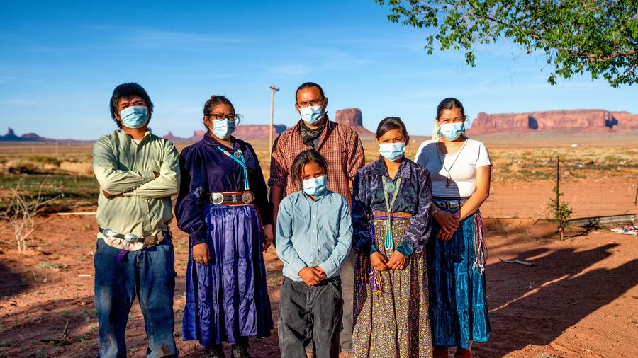 A Navajo family with Covid-19 masks outside their home in Monument Valley, Arizona