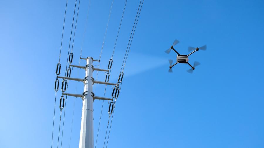 A drone inspecting electricity power lines
