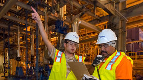 two workers in an industrial facility