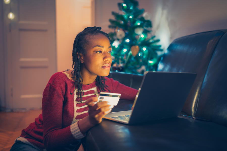 woman using credit card online while at home