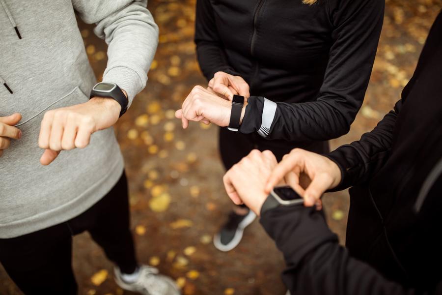 group of people checking their wearable devices