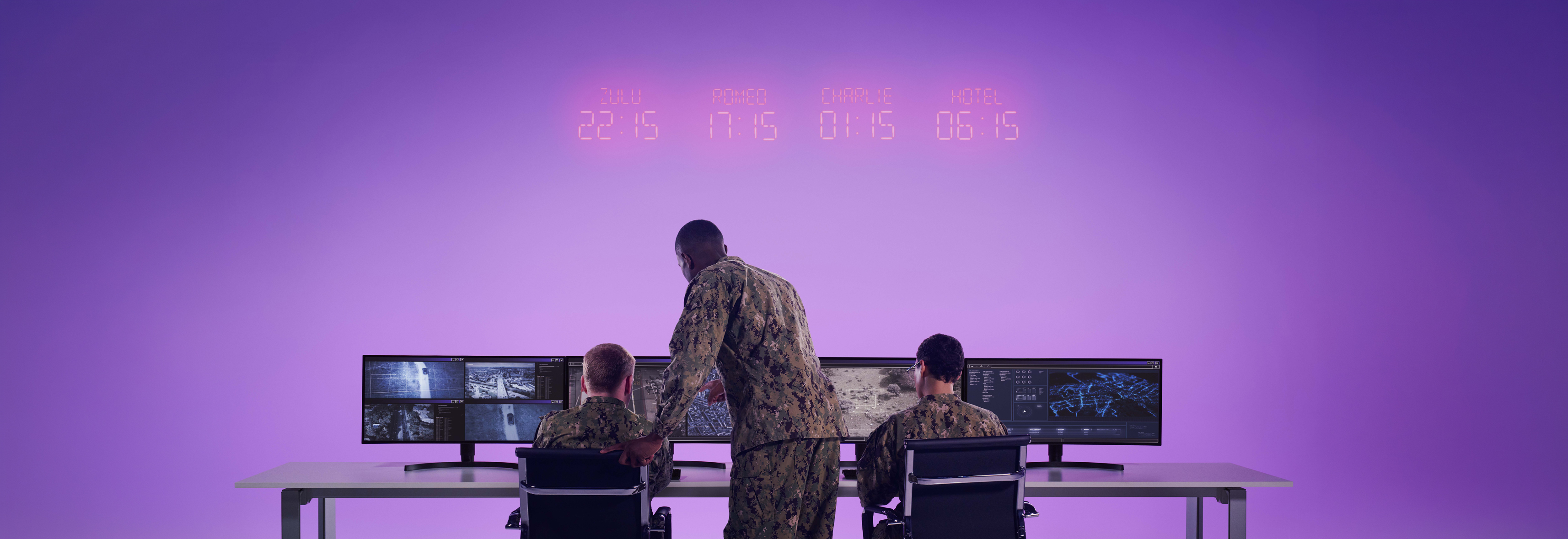 team from behind while working on screens