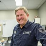 Man in pilot uniform smiling at camera