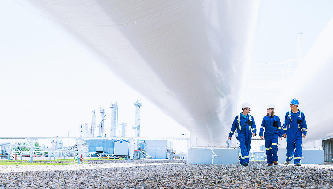 Three coworkers walking together at a power plant