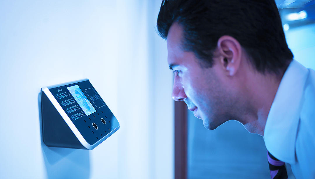 man leaning into scanning keypad
