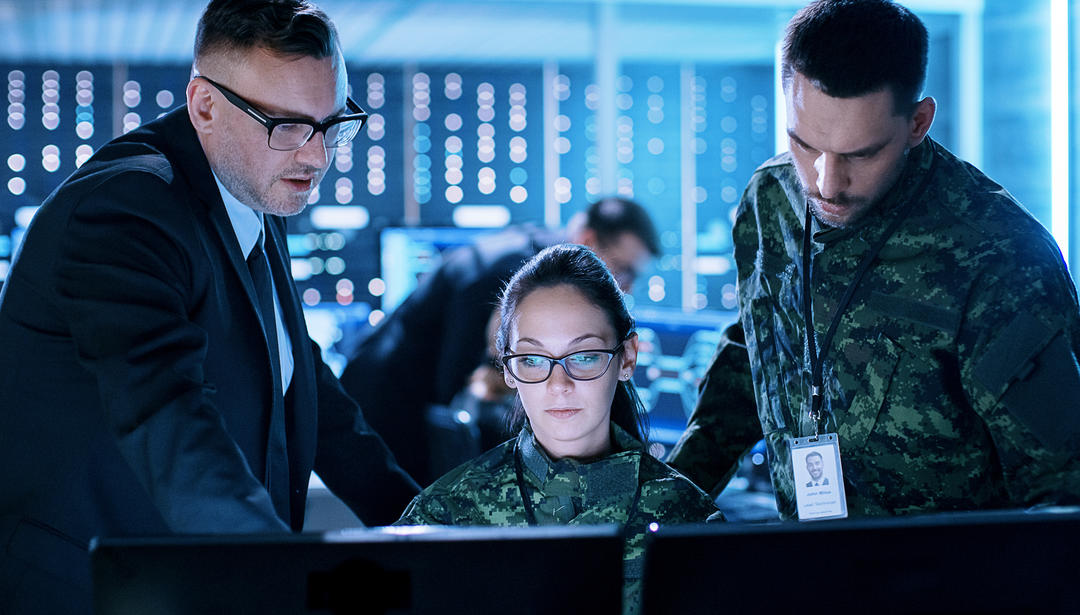 Analysts working at a computer screen