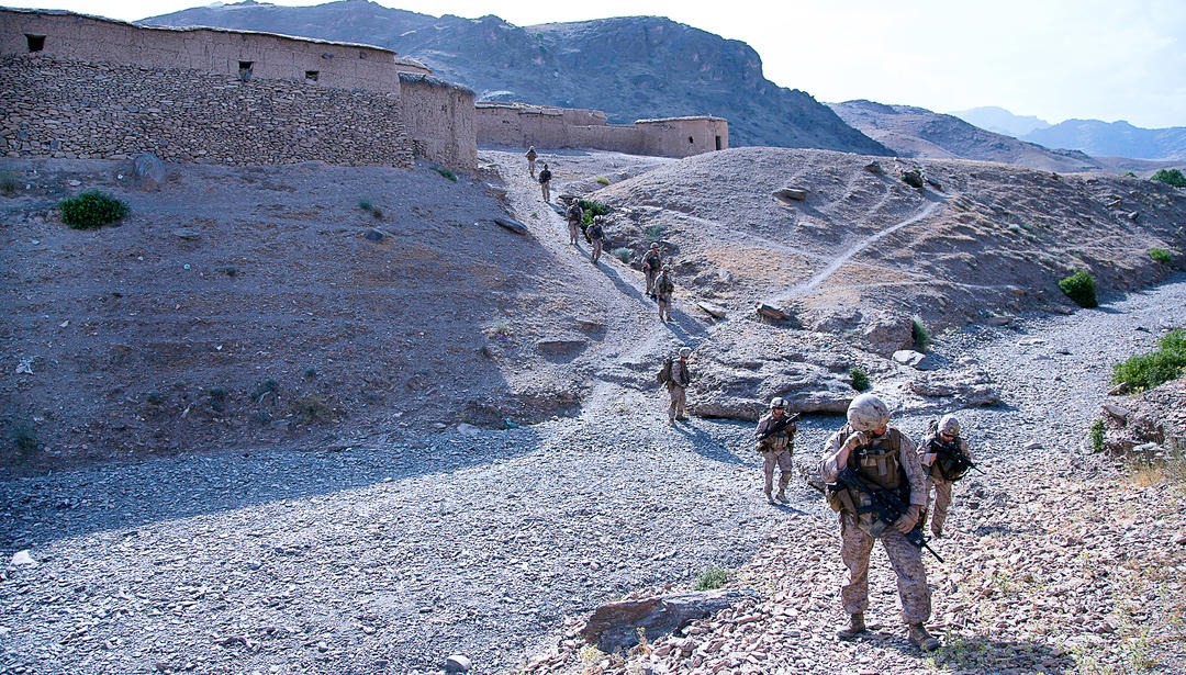 Soldiers walking through desert