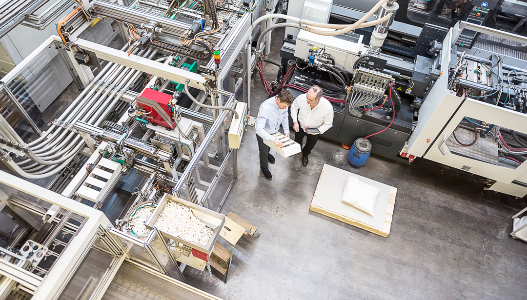 view from overhead of two coworkers in a stock room