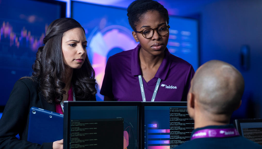 Leidos employees discussing a project 