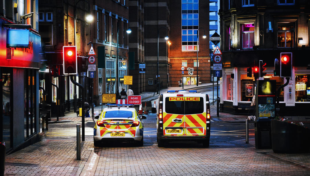 UK police vehicles at city traffic lights