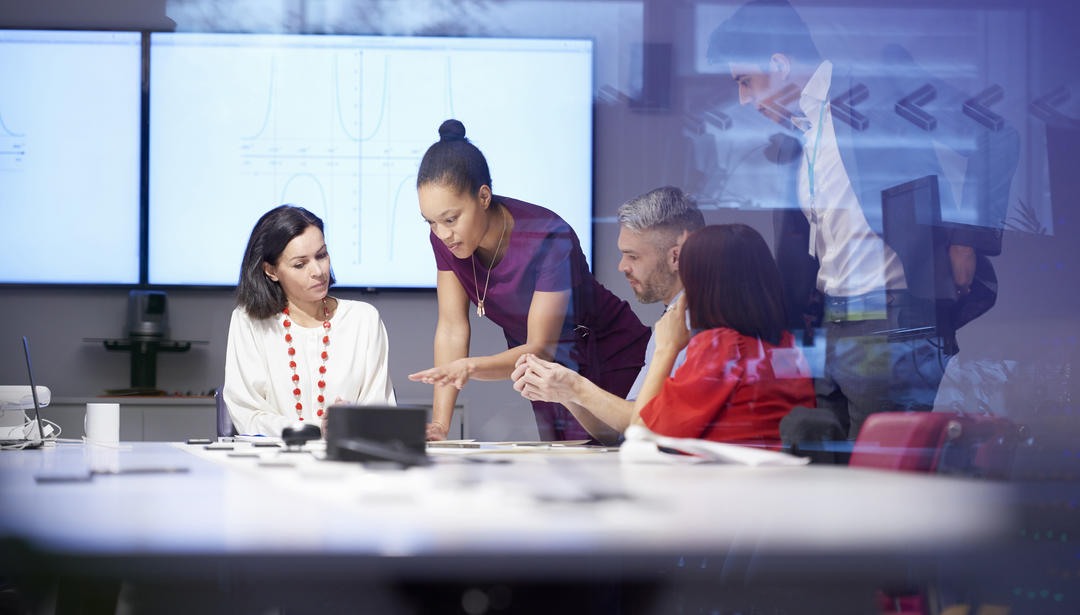 group of people around a table in discussion