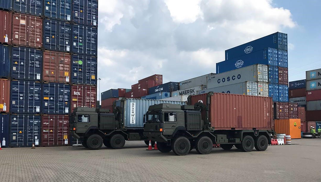 truck infront of shipping containers