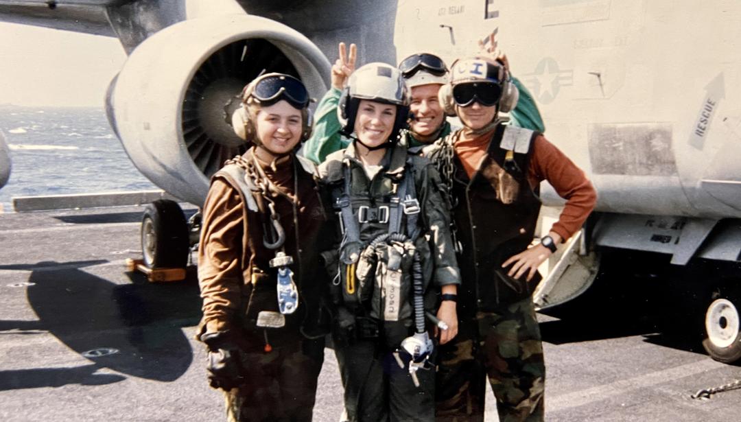 Lisa Delcore standing next to aircraft with other people