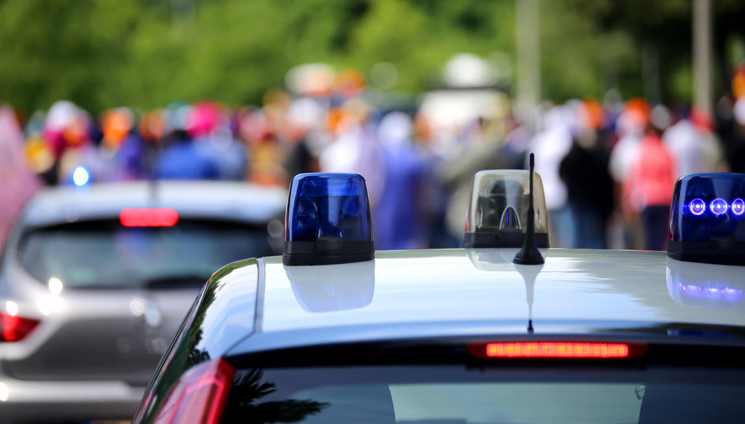 Police vehicle with crowd