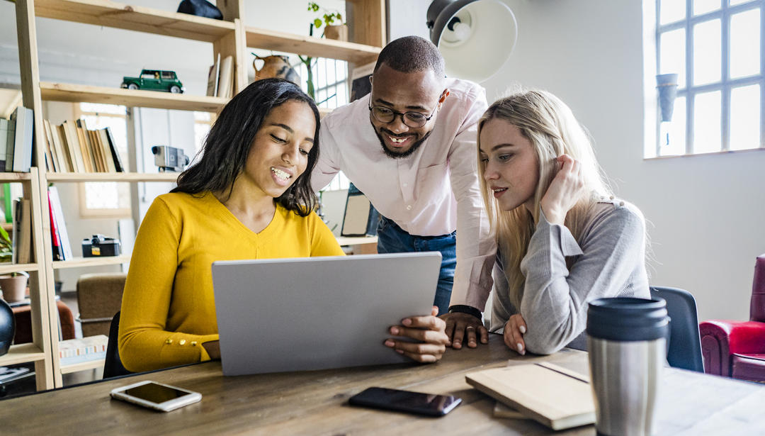 three people at a computer