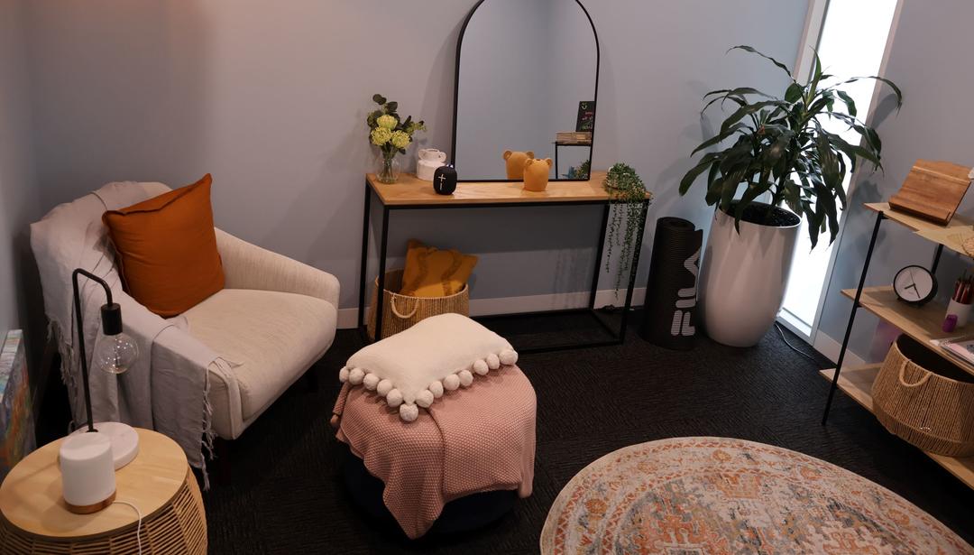 A room with a bookcase and an armchair